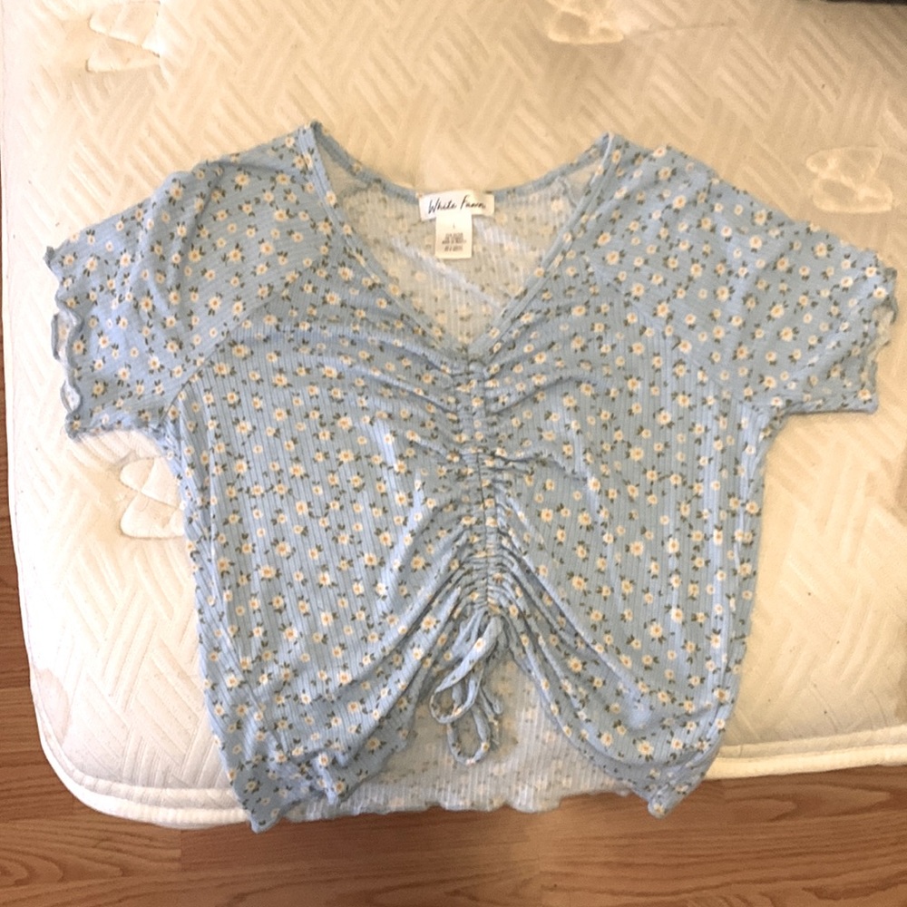 This shirt is so soft and comfortable,It’s a light blue shirt with cute flowers